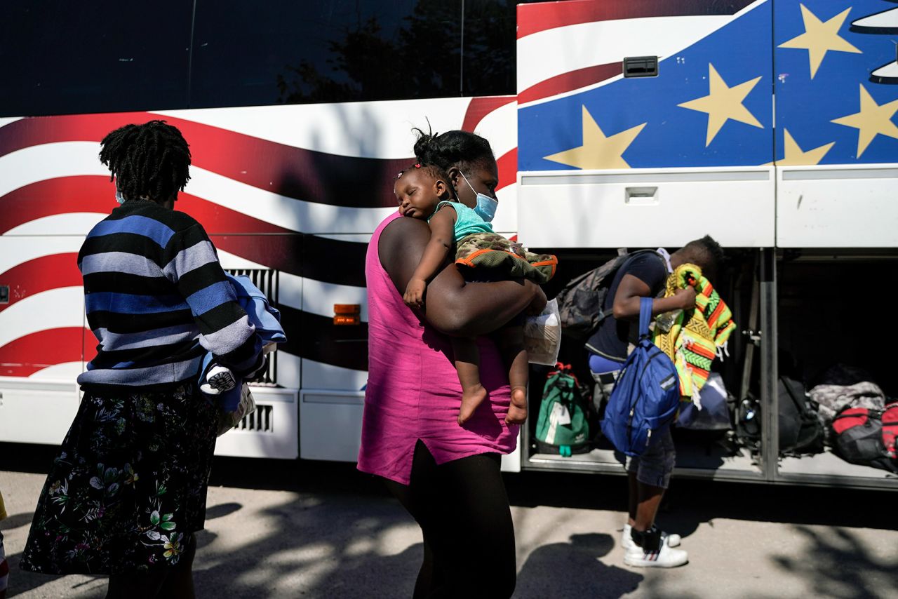 Migrants prepare to board a bus toward Houston provided by a humanitarian organization after they were released from US Customs and Border Protection custody in Del Rio on Thursday, September 23.