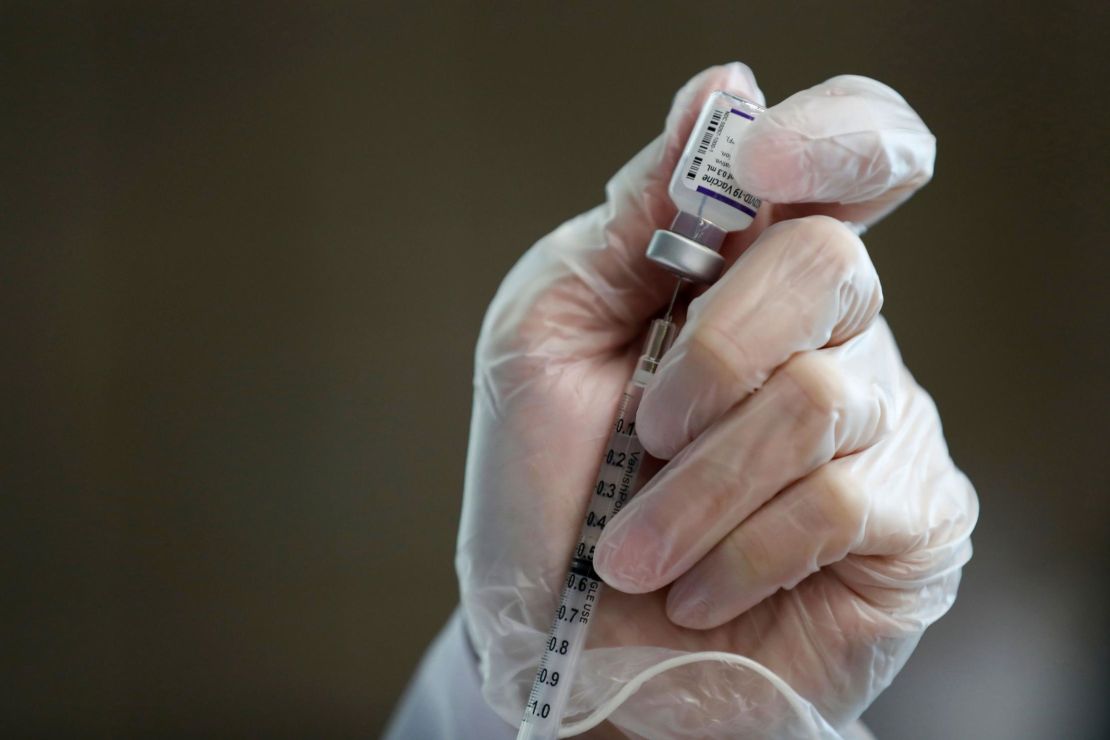 A health care worker fills a syringe with a dose of the Pfizer/BioNTech Covid-19 vaccine at a clinic in California State University. Los Angeles County began offering booster shots Friday.