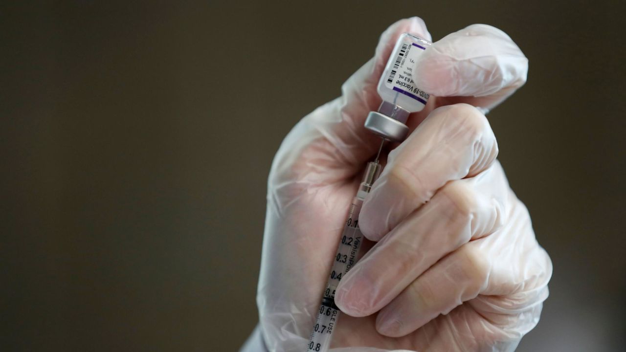 A health care worker fills a syringe with a dose of the Pfizer/BioNTech Covid-19 vaccine at a clinic in California State University. Los Angeles County began offering booster shots Friday.