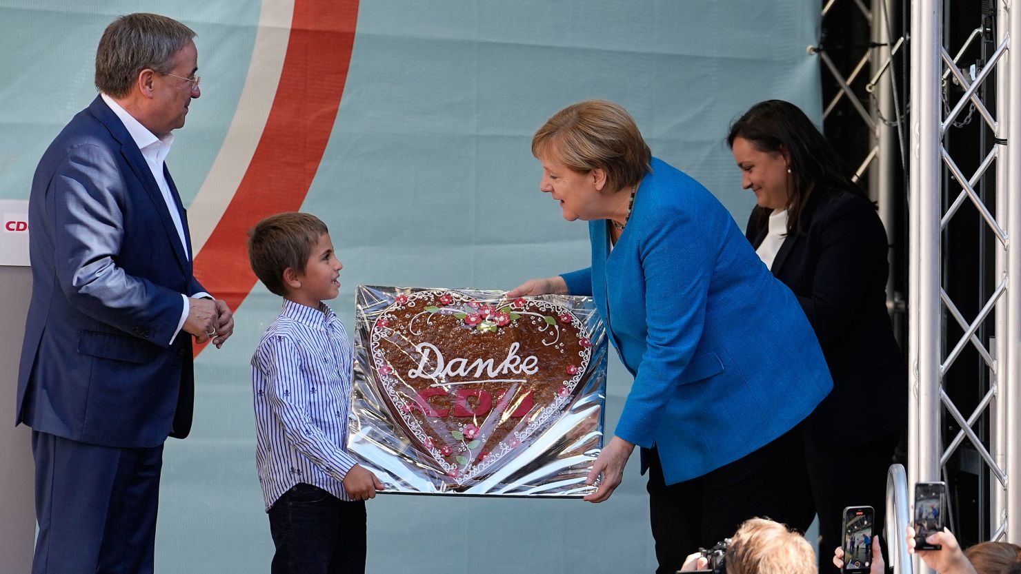 Chancellor Angela Merkel is given a traditional gingerbread reading "Thanks CDU" beside Armin Laschet, top candidate for the upcoming election, left, at their party's final campaign event in Aachen on Saturday.