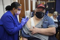 Shana Alesi administers a Covid-19 booster vaccine to Marine Corps veteran Bill Fatz at the Edward Hines Jr. VA Hospital on September 24 in Hines, Illinois.