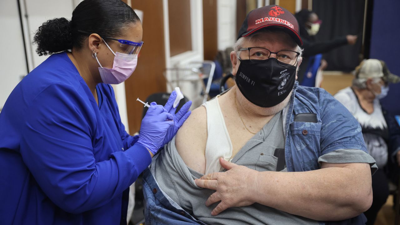 Shana Alesi administers a Covid-19 booster vaccine to Marine Corps veteran Bill Fatz at the Edward Hines Jr. VA Hospital on September 24 in Hines, Illinois.
