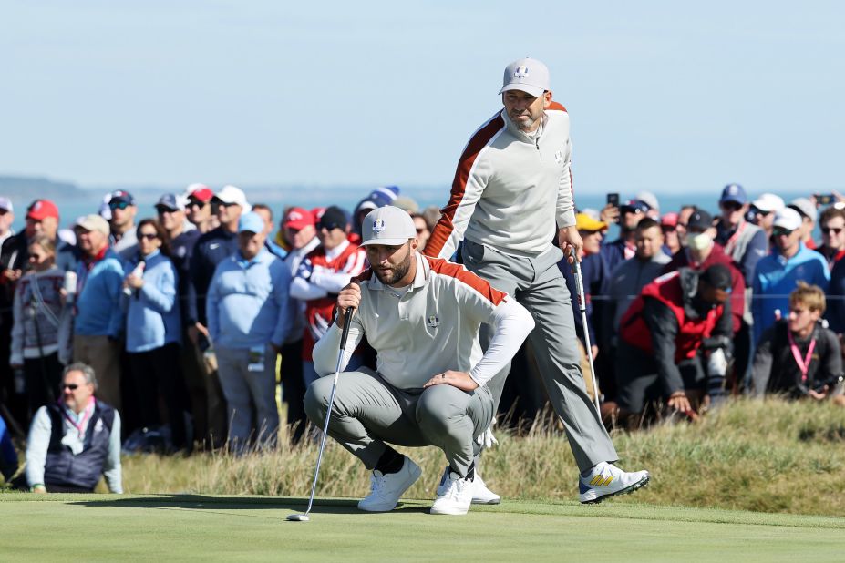 Team Europe's Jon Rahm (left) and Sergio Garcia line up a putt on the 15th green during Saturday morning Foursome matches on September 25. <a href="https://www.cnn.com/2021/09/25/golf/sergio-garcia-ryder-cup-history-spt-intl/index.html" target="_blank">Garcia made Ryder Cup history</a> by becoming the player with the most matches won in the tournament's history, after their victory over Brooks Koepka and Daniel Berger of Team US.