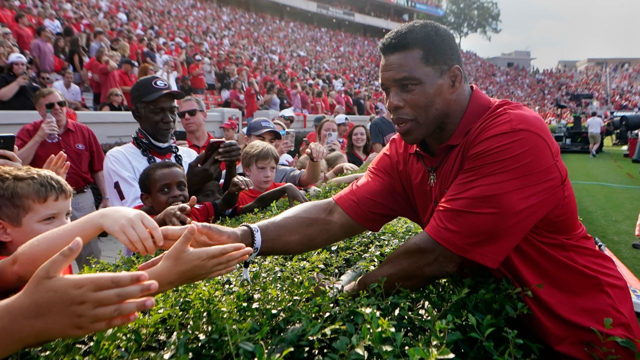 Former Georgia running back and Republican candidate for US Senate Herschel Walker greets fans before a college football game between UAB and Georgia Saturday, Sept. 11, 2021, in Athens, Georgia.
