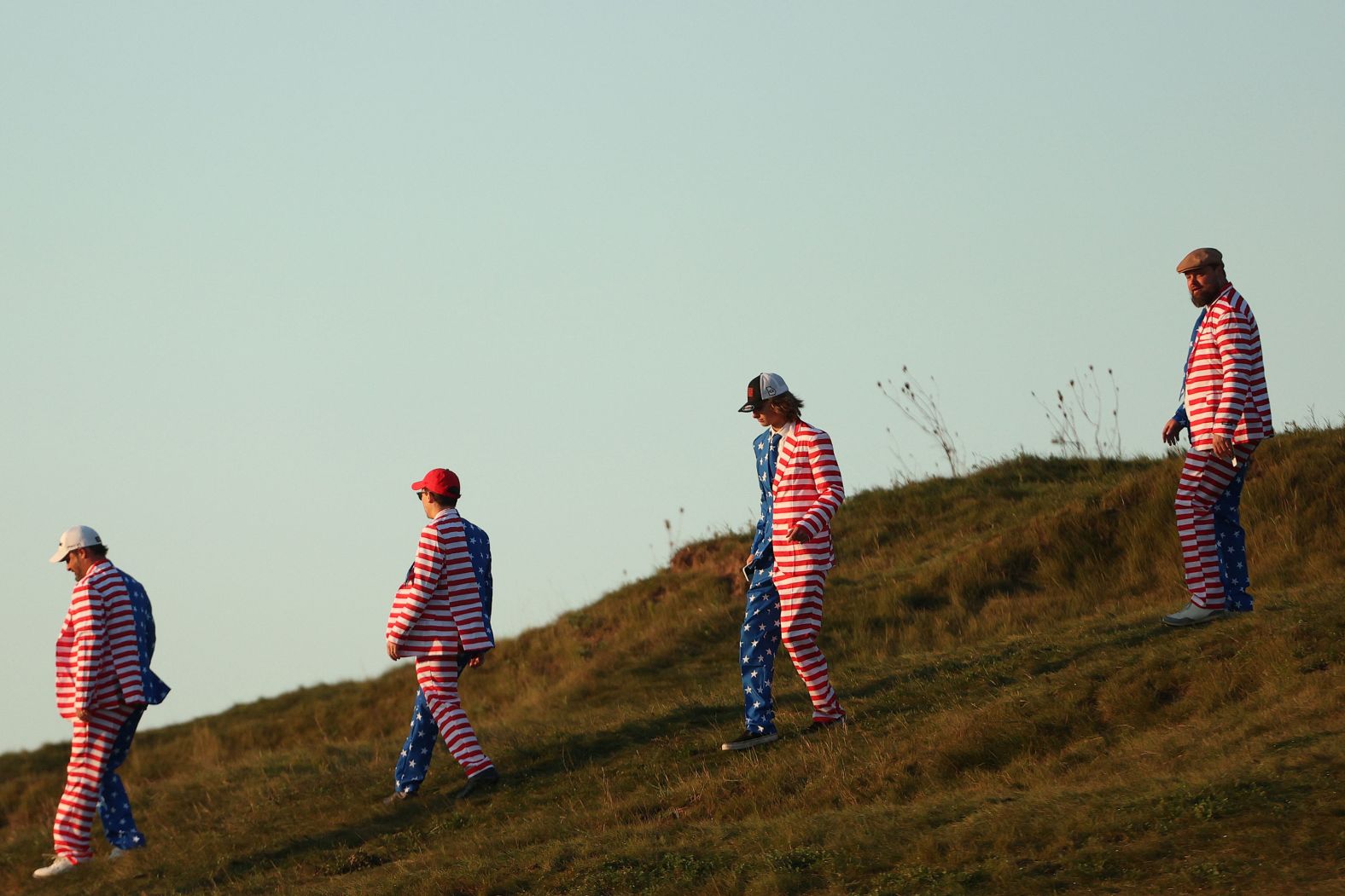 Fans of Team US walk across the course.