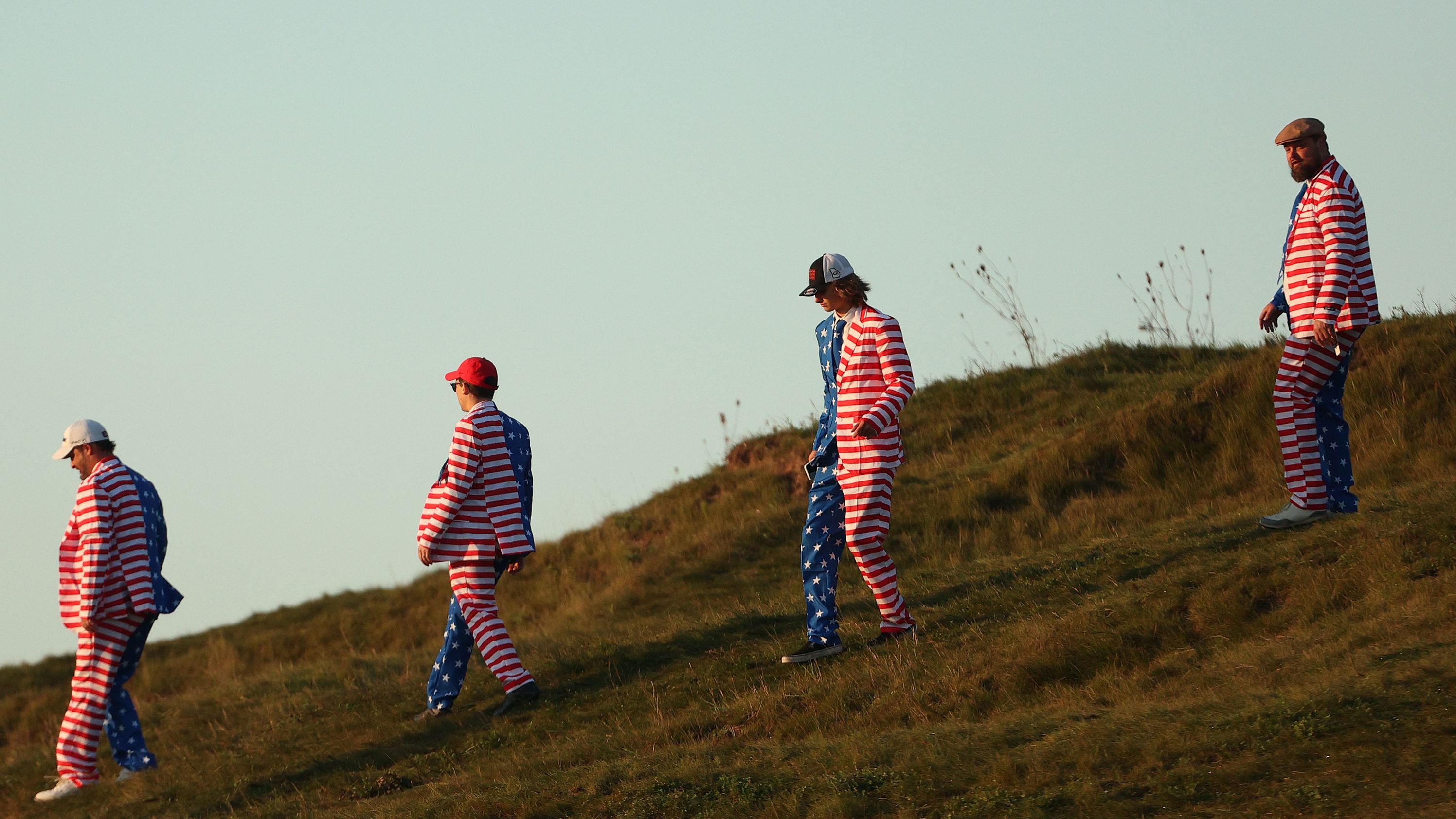 Fans of Team US walk across the course.