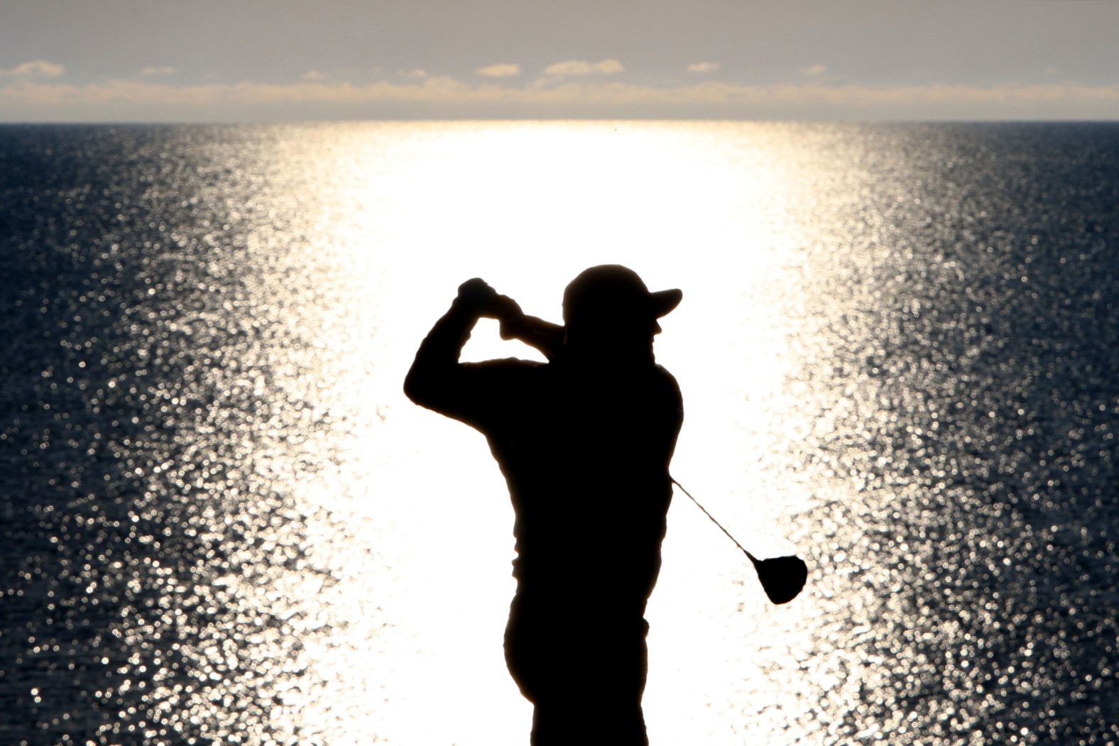 Rahm plays his shot from the fourth tee.