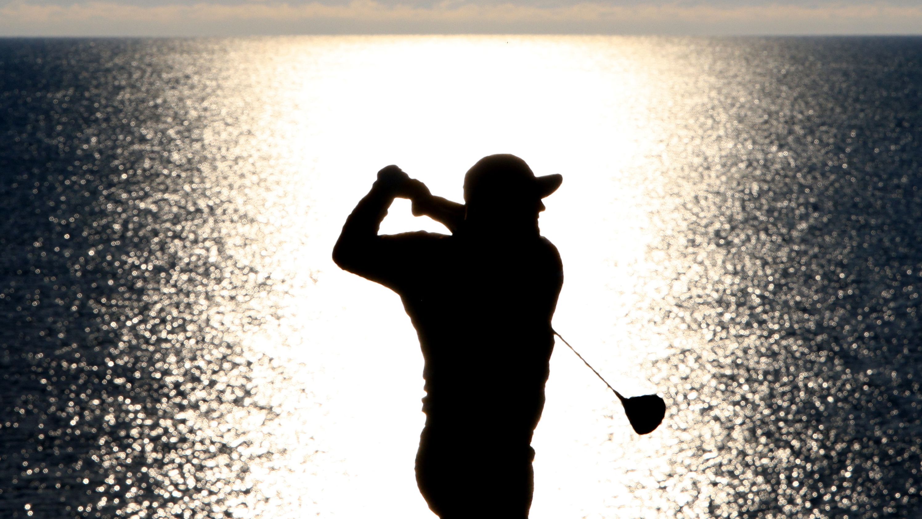 Rahm plays his shot from the fourth tee.
