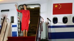In this photo released by China's Xinhua News Agency, Huawei CFO Meng Wanzhou waves as she steps out of an airplane after arriving at Shenzhen Bao'an International Airport in Shenzhen in southern China's Guangdong Province, Saturday, Sept. 25, 2021. A top executive from global communications giant Huawei Technologies returned to China on Saturday following what amounted to a high-stakes prisoner swap with Canada and the U.S. (Jin Liwang/Xinhua via AP)