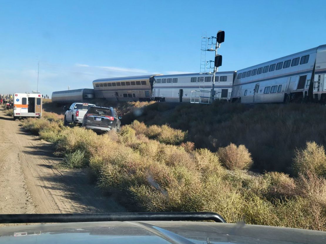 In this photo provided by Kimberly Fossen, an ambulance is parked at the scene of an Amtrak train derailment on Saturday in Montana.