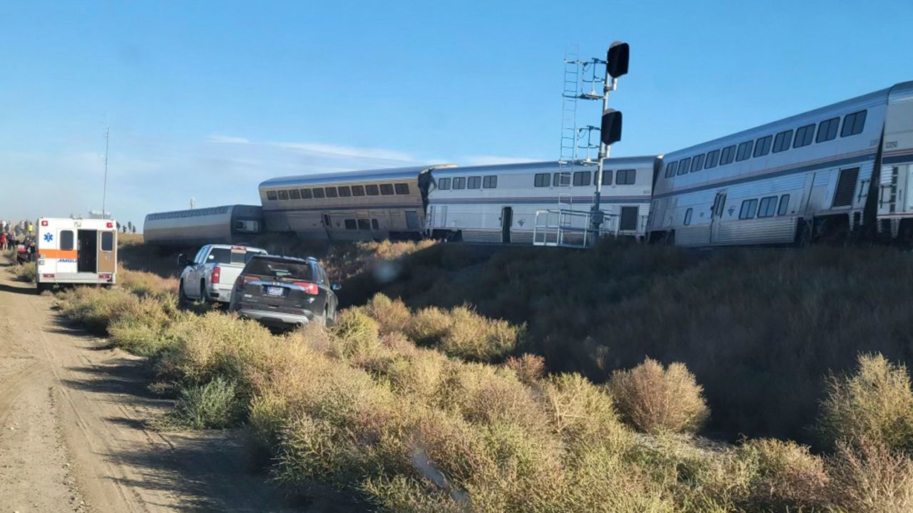 In this photo provided by Kimberly Fossen an ambulance is parked at the scene of an Amtrak train derailment on Saturday, Sept. 25, 2021, in north-central Montana. Multiple people were injured when the train that runs between Seattle and Chicago derailed Saturday, the train agency said. (Kimberly Fossen via AP)