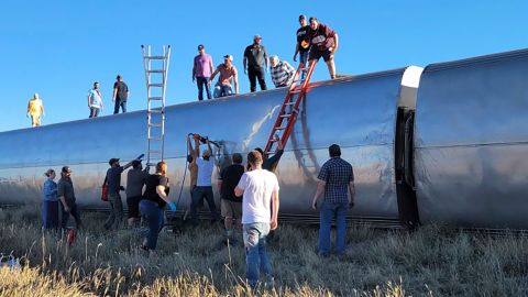 In this photo provided by Kimberly Fossen people work at the scene of an Amtrak train derailment on Saturday, Sept. 25, 2021, in north-central Montana. Multiple people were injured when the train that runs between Seattle and Chicago derailed Saturday, the train agency said. (Kimberly Fossen via AP)