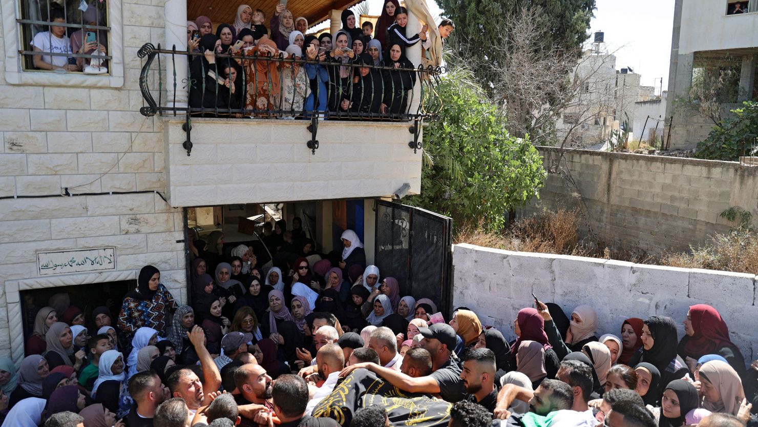 Mourners carry the body of Osama Sobh, a Palestinian killed by Israeli soldiers during clashes near Jenin, during his funeral in the village of Burqin in the West Bank on September 26.