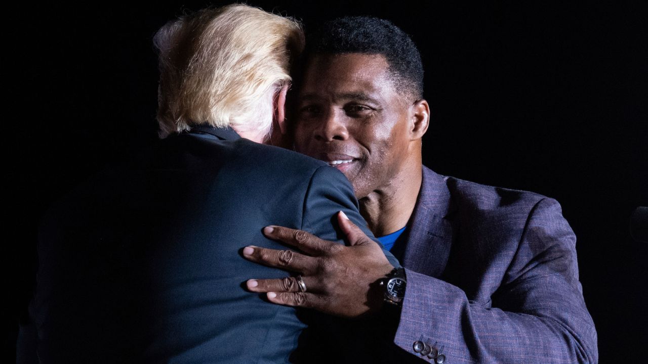 Former President Donald Trump hugs Georgia Senate candidate Herschel Walker during his Save America rally in Perry, Ga., on Saturday, Sept. 25, 2021.