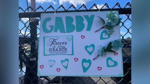 A sign honoring Gabby Petito hangs across the street from the Long Island funeral home where her family and members of the public gathered Sunday, September 26, 2021.