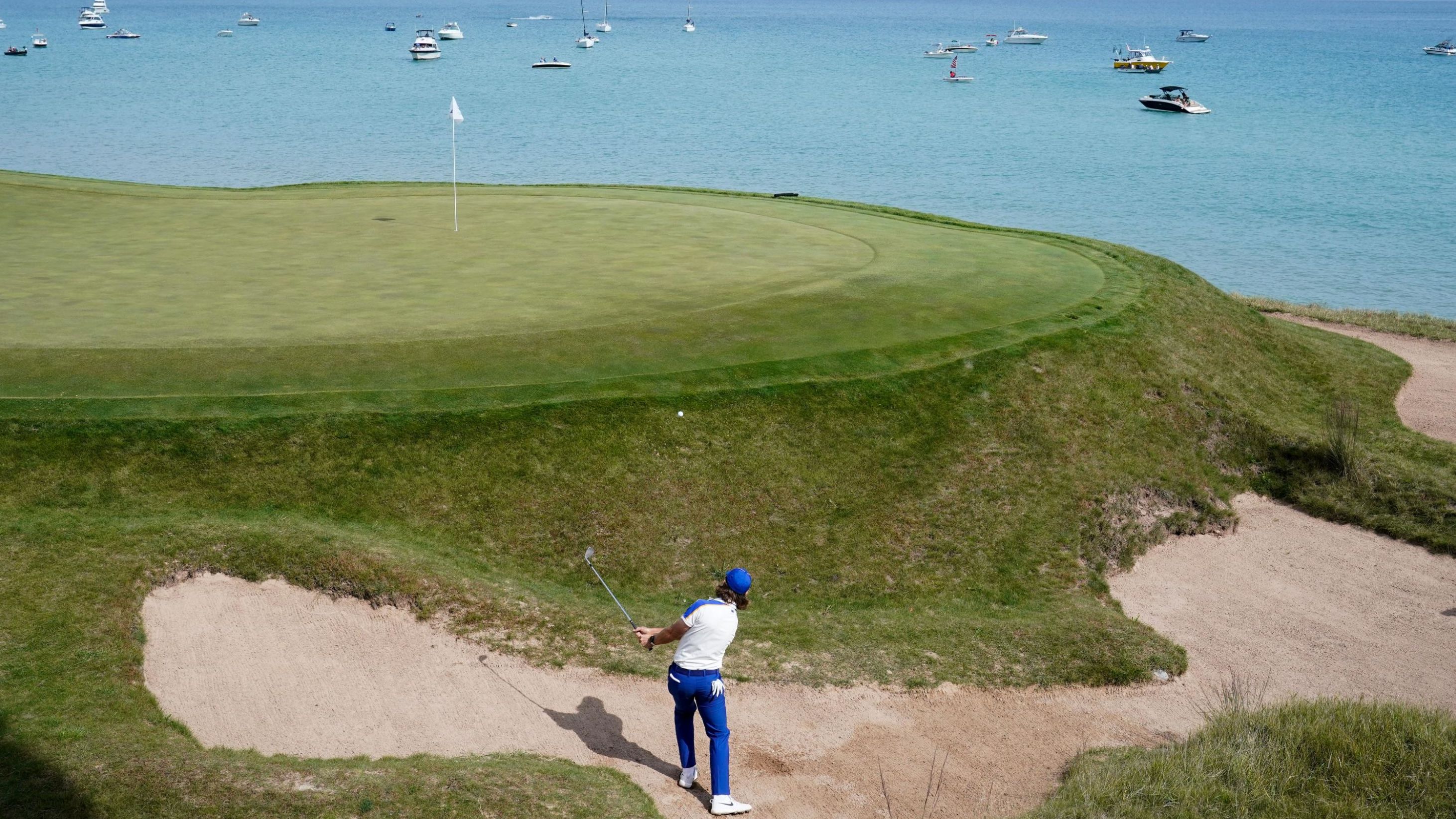 Team Europe's Tommy Fleetwood hits from a bunker on the third hole.