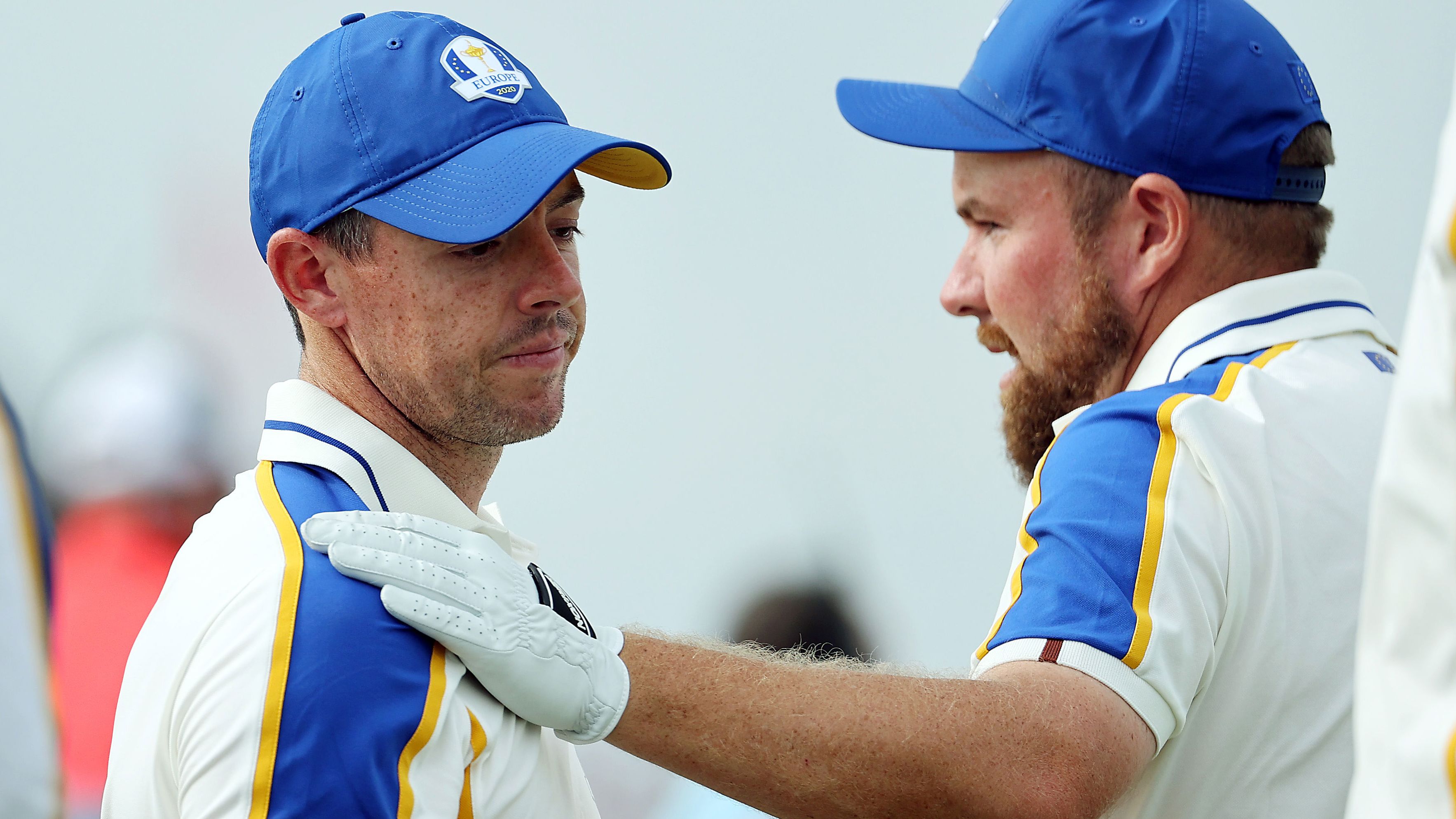 Shane Lowry hugs McIlroy on the 16th green after losing to Patrick Cantlay.