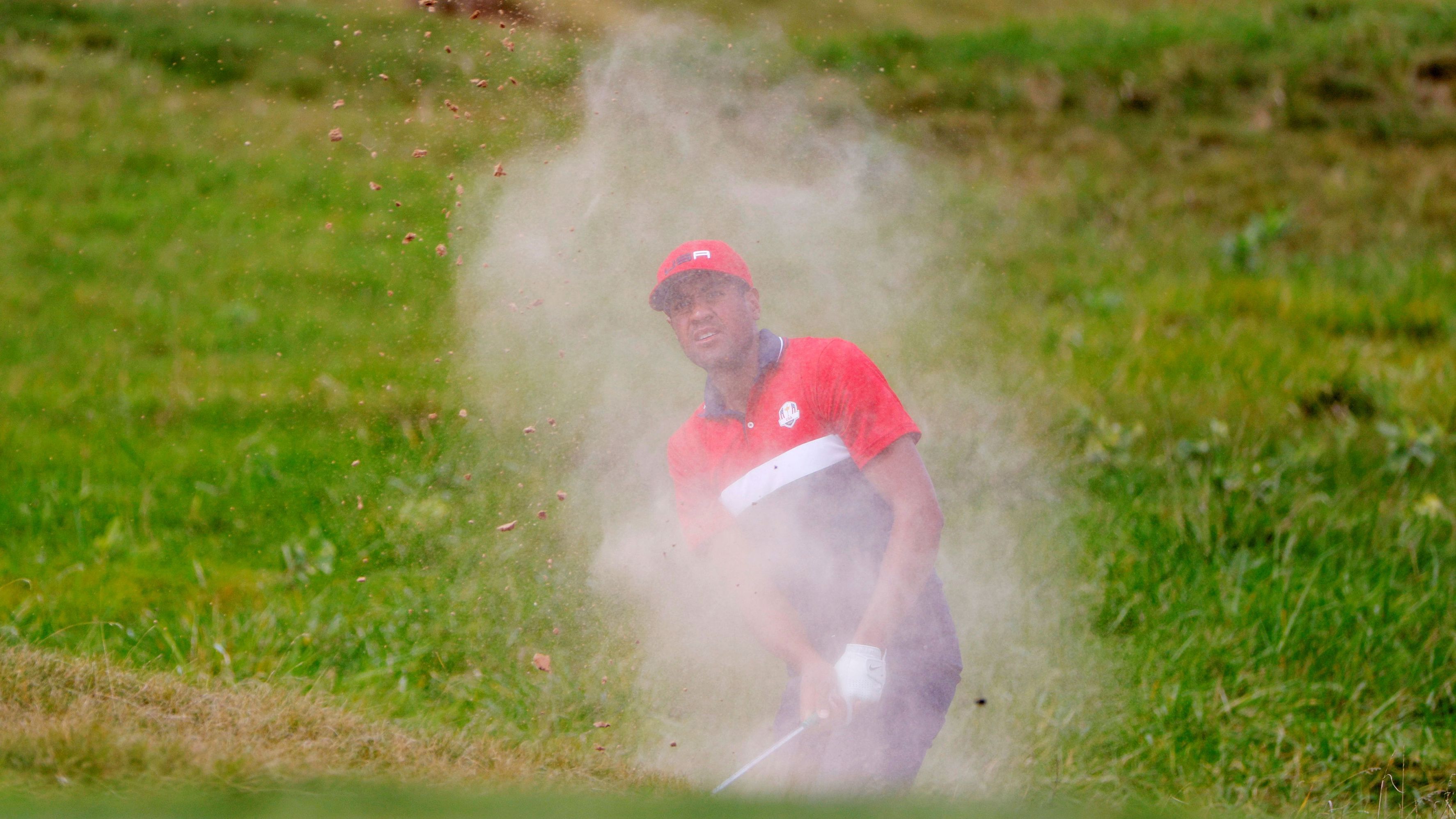 Team US' Tony Finau plays out from the bunker on the first hole.