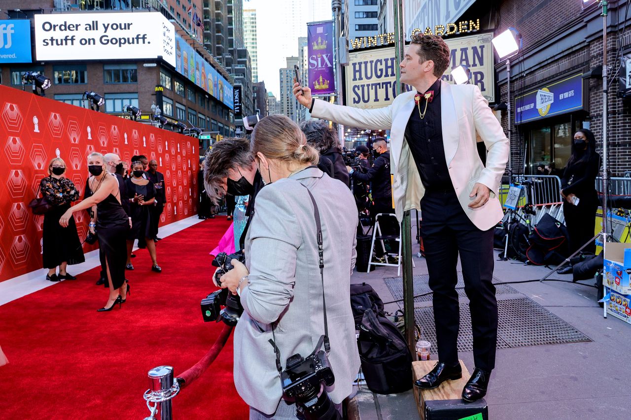 Matthew Morrison takes a picture of the red carpet arrivals.
