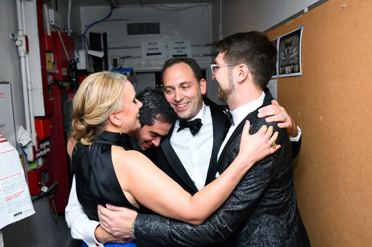 From left, Katie Kresek, Justin Levine, Matt Stine, and Charlie Rosen embrace backstage after winning the award for best orchestrations for "Moulin Rouge! The Musical."