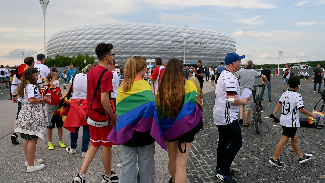 Fans wearing the rainbow flag outside of the Allianz Arena at Euro 2020