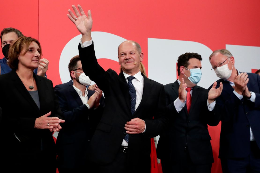 SPD leader Olaf Scholz waves to supporters at the party's headquarters in Berlin, on September 26.