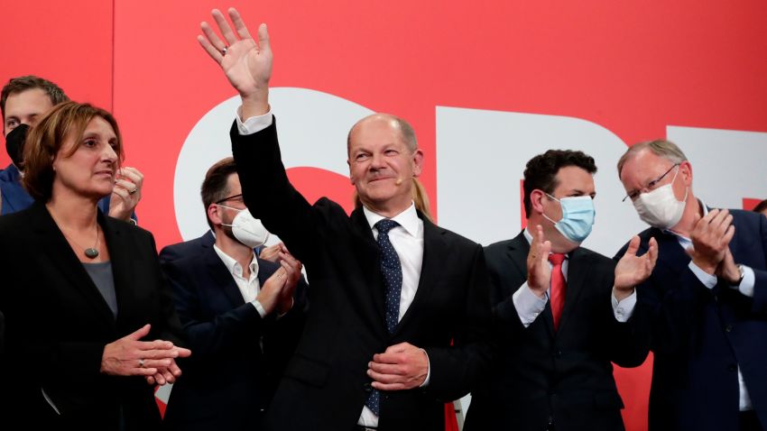 Olaf Scholz, top candidate for chancellor of the Social Democratic Party (SPD) waves to his supporters after German parliament election at the party's headquarters in Berlin, Sunday, Sept. 26, 2021. (AP Photo/Lisa Leutner)