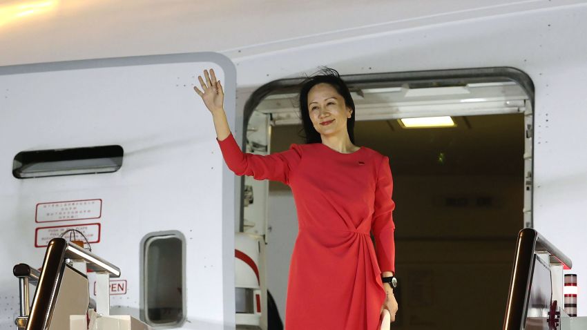 In this photo released by China's Xinhua News Agency, Huawei CFO Meng Wanzhou waves as she steps out of an airplane after arriving at Shenzhen Bao'an International Airport in Shenzhen in southern China's Guangdong Province, Saturday, Sept. 25, 2021. A top executive from global communications giant Huawei Technologies returned to China on Saturday following what amounted to a high-stakes prisoner swap with Canada and the U.S. (Jin Liwang/Xinhua via AP)