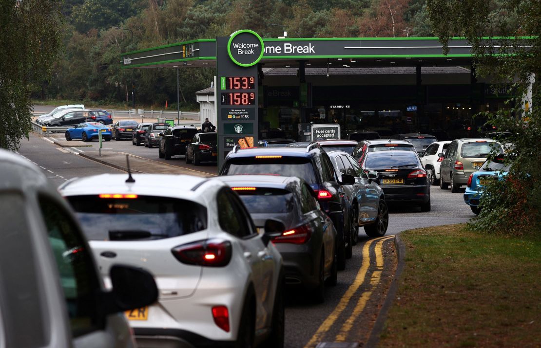 Motorists queue for petrol and diesel fuel at a petrol station off of the M3 motorway near Fleet, west of London, on September 26.