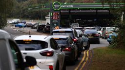 Motorists queue for petrol and diesel fuel at a petrol station off of the M3 motorway near Fleet, west of London on September 26, 2021. - Britain's transport secretary Grant Shapps on Sunday accused lorry industry representatives of helping to spark petrol panic-buying, as he defended a U-turn on post-Brexit immigration policy to ease an escalating supply crisis. (Photo by Adrian DENNIS / AFP) (Photo by ADRIAN DENNIS/AFP via Getty Images)