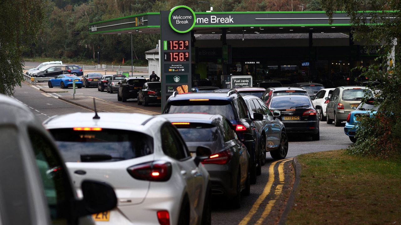 Motorists queue for petrol and diesel fuel at a petrol station off of the M3 motorway near Fleet, west of London, on September 26.