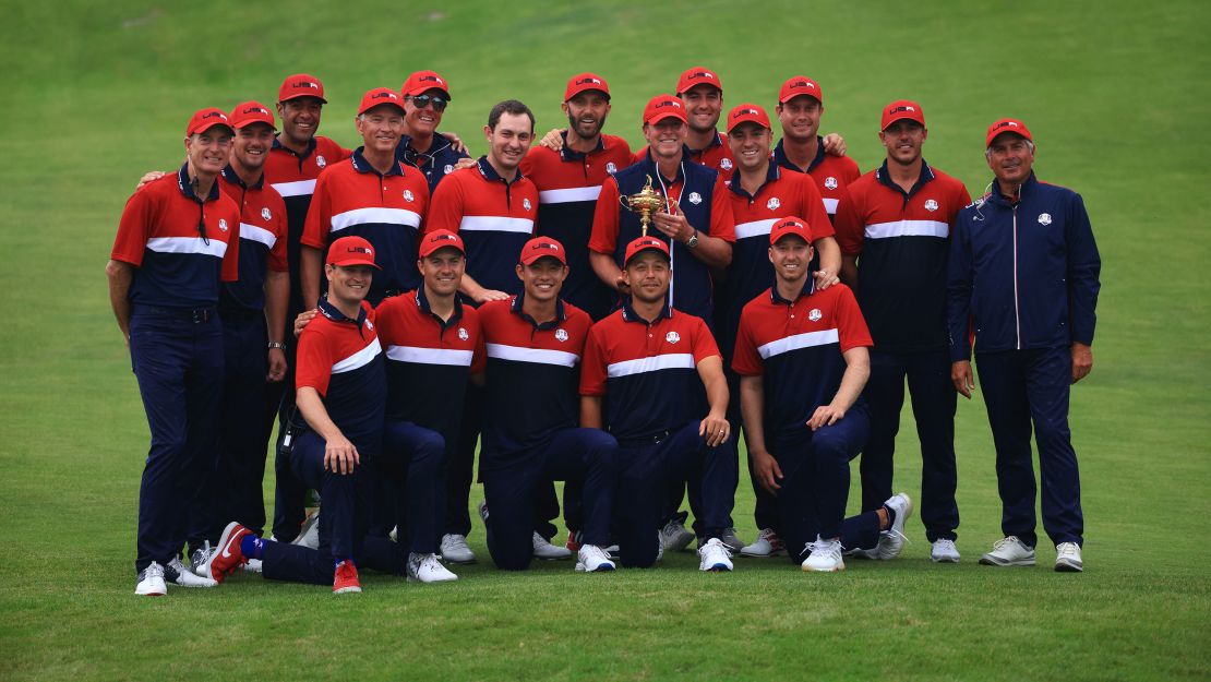 Team US celebrates with the Ryder Cup after defeating Team Europe.