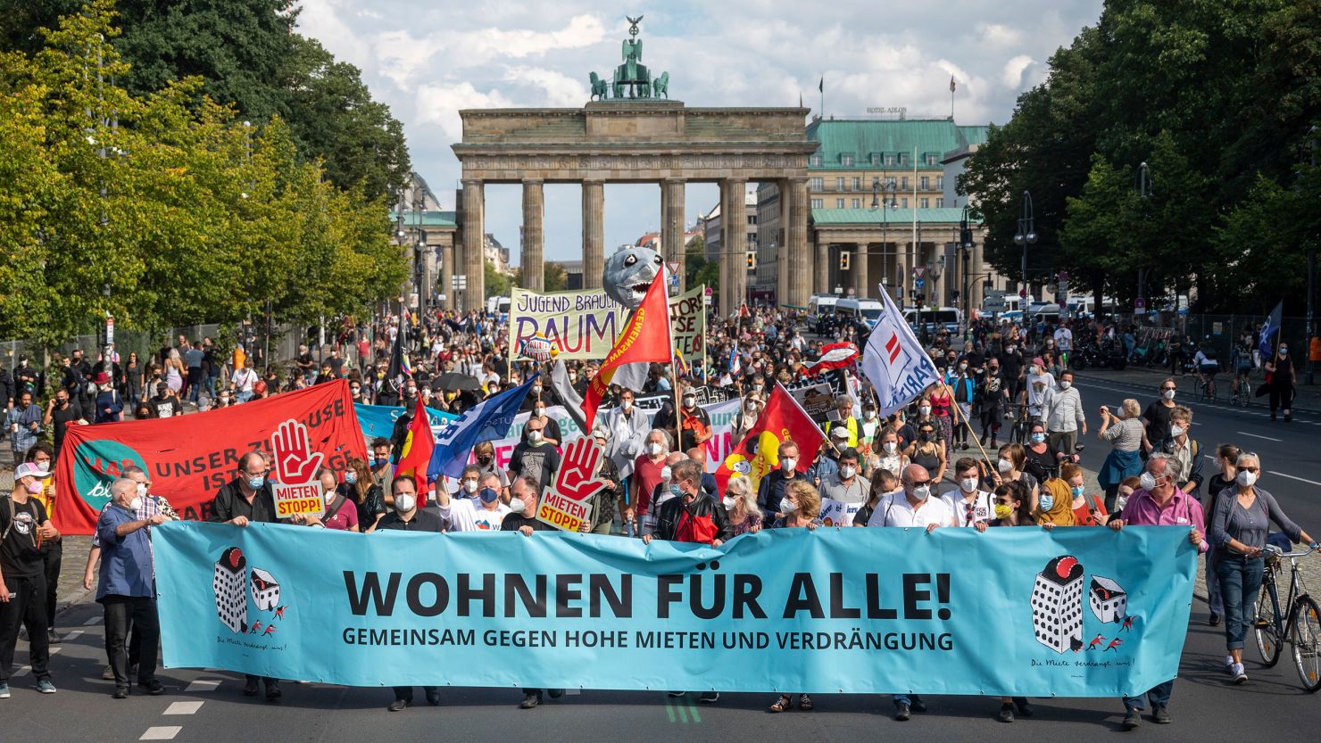 At a protest against high rents in Berlin, demonstrators hold a banner with the inscription 'Wohnen fuer Alle!' (Housing for All) on September 11, 2021. 