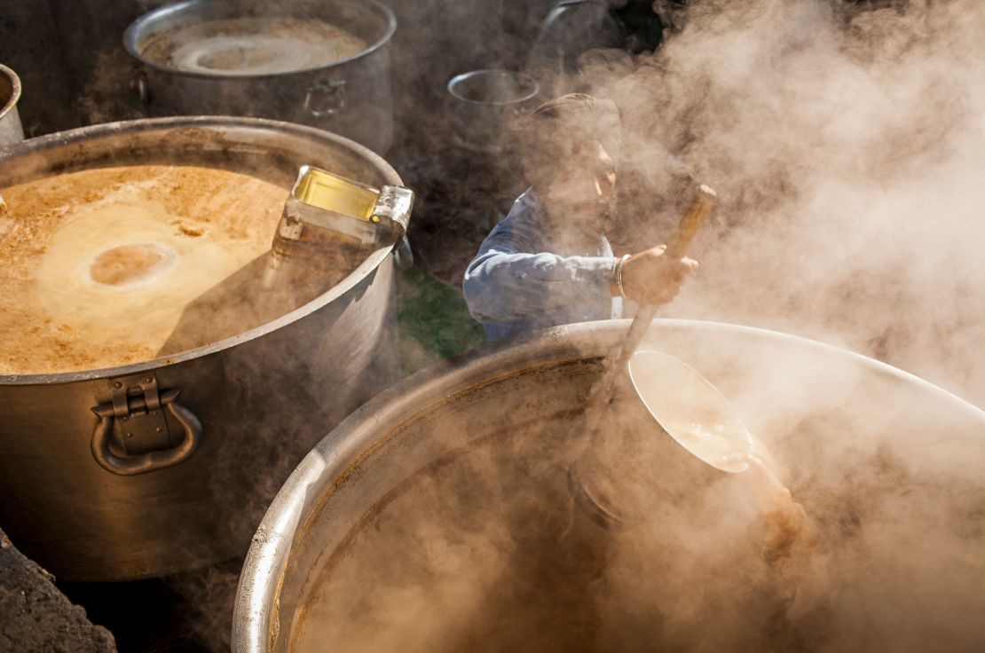 A volunteer cooks chai for the thousands of pilgrims who visit the Golden Temple each day. 