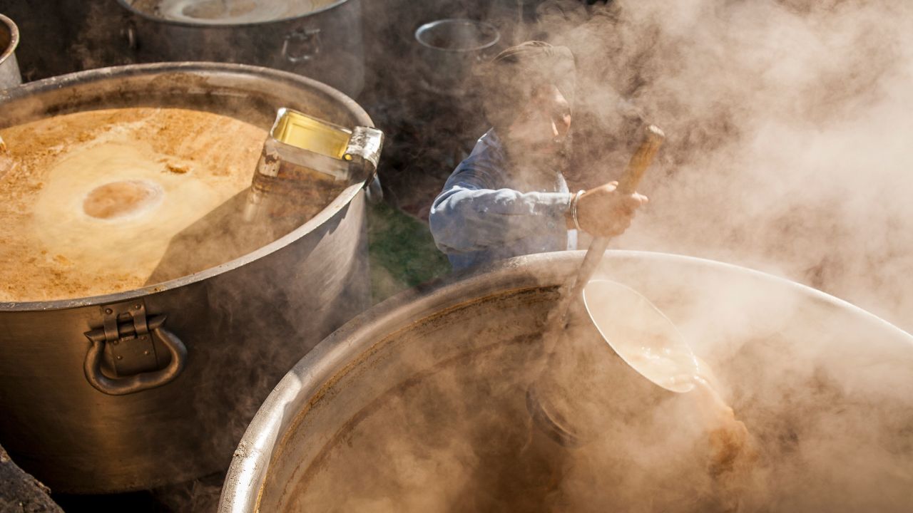 A volunteer cooks chai for the thousands of pilgrims who visit the Golden Temple each day.