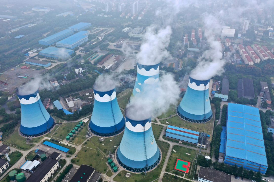 Steam billows out of the cooling towers at a coal-fired power station in Nanjing, China.