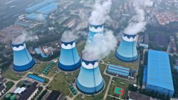 Steam billows out of the cooling towers at a coal-fired power station in Nanjing in east China's Jiangsu province on Monday, Sept. 27, 2021. Global shoppers face possible shortages of smartphones and other goods ahead of Christmas after power cuts to meet government energy use targets forced Chinese factories to shut down and left some households in the dark. (Chinatopix via AP)