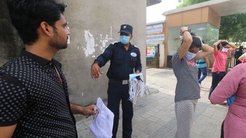 Test takers receive fresh disposable face masks as they prepare to take the Rajasthan Eligibility Exam for Teachers (REET) at an examination center in Jaipur, India, on September 26.