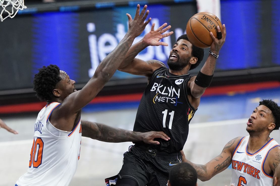 Brooklyn Nets' Kyrie Irving (center) may be unable to play in front of NBA fans in New York City this season, following new vaccine mandates that could bar players from competing in home games if they are not vaccinated or exempted.