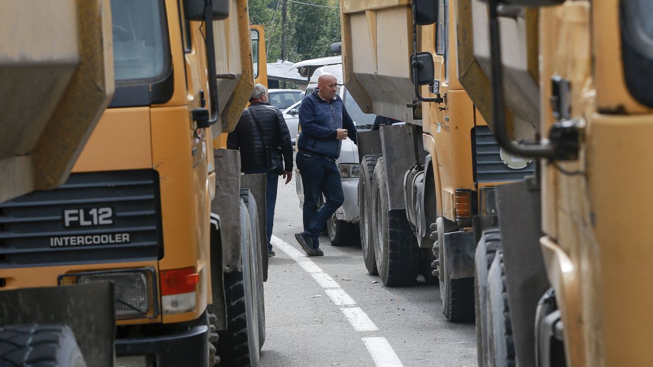 Local Serbs stand beside a roadblock on the route to the northern Kosovo border crossing of Jarinje on September 21.