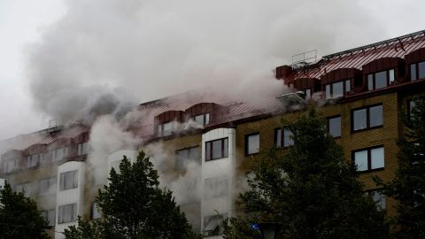 Smoke billows from a building as emergency services fight a fire caused by an explosion in central Gothenburg.