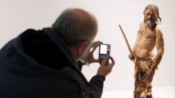A man takes pictures of a statue representing an iceman named Oetzi, discovered on 1991 in the Italian Schnal Valley glacier, is displayed at the Archaeological Museum of Bolzano on February 28, 2011 during an official presentation of the reconstrution. Based on three-dimensional images of the mummy's skeleton as well as the latest forensic technology, a new model of the living Oetzi has been created by Dutch experts Alfons and Adrie Kennis.   AFP PHOTO / Andrea Solero        (Photo credit should read Andrea Solero/AFP via Getty Images)