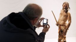 A man takes pictures of a statue representing an iceman named Oetzi, discovered on 1991 in the Italian Schnal Valley glacier, is displayed at the Archaeological Museum of Bolzano on February 28, 2011 during an official presentation of the reconstrution. Based on three-dimensional images of the mummy's skeleton as well as the latest forensic technology, a new model of the living Oetzi has been created by Dutch experts Alfons and Adrie Kennis. AFP PHOTO / Andrea Solero (Photo credit should read Andrea Solero/AFP via Getty Images)