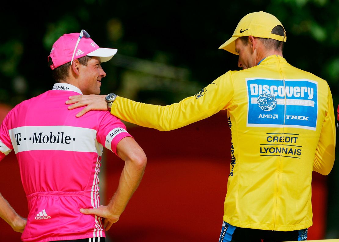 Armstrong (right) and Ullrich speak on the podium during the 2005 Tour de France.