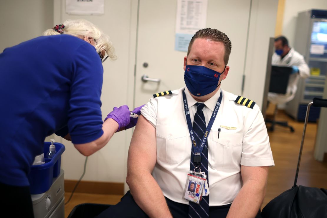 nited Airlines pilot Steve Lindland receives a Covid-19 vaccine at O'Hare International Airport in March 2021. 