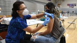 WINTER SPRINGS, FLORIDA, UNITED STATES - 2021/09/11: Nurse Susanna Bryan administers a dose of the Pfizer COVID-19 vaccine to Joann Cortes at a vaccination clinic at Winter Springs High School. As of September 10, 2021, 54% of Florida's population has been fully vaccinated. (Photo by Paul Hennessy/SOPA Images/LightRocket via Getty Images)