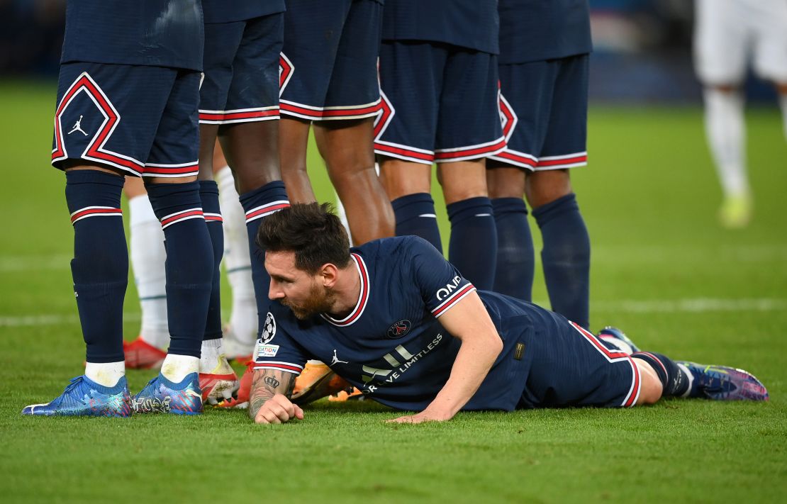 Messi lies behind the PSG wall as they defend a free kick against Manchester City. 