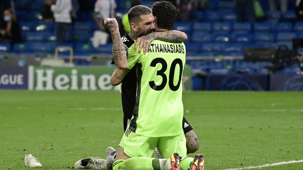 Goalkeeper Giorgos Athanasiadis celebrates with teammate Dimitrios Kolovos at the final whistle.