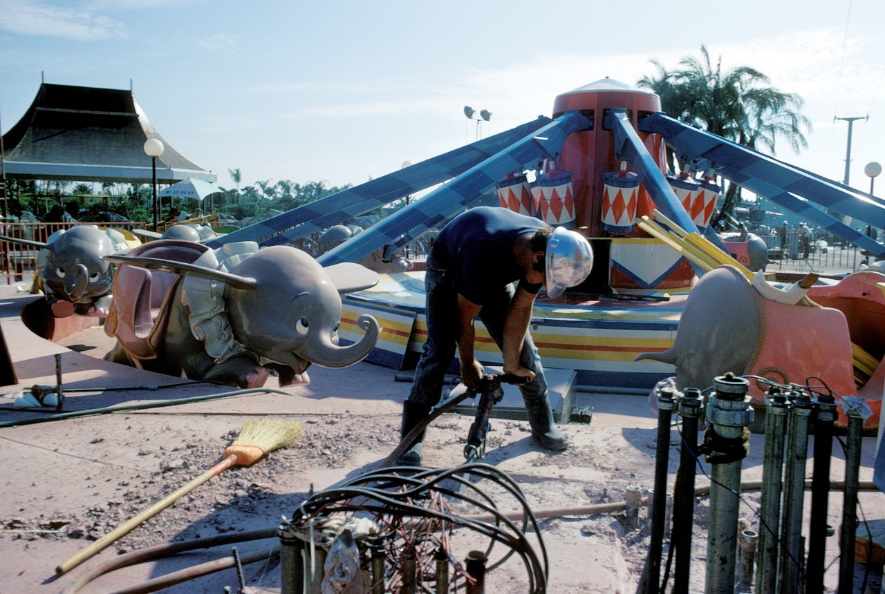 A man works on the Dumbo carousel ride in 1971.
