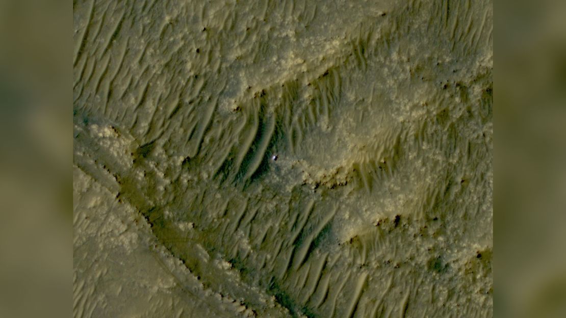 The Mars Reconnaissance Orbiter took this photo of Perseverance, visible as a white speck, in the South Séítah area of Jezero Crater.